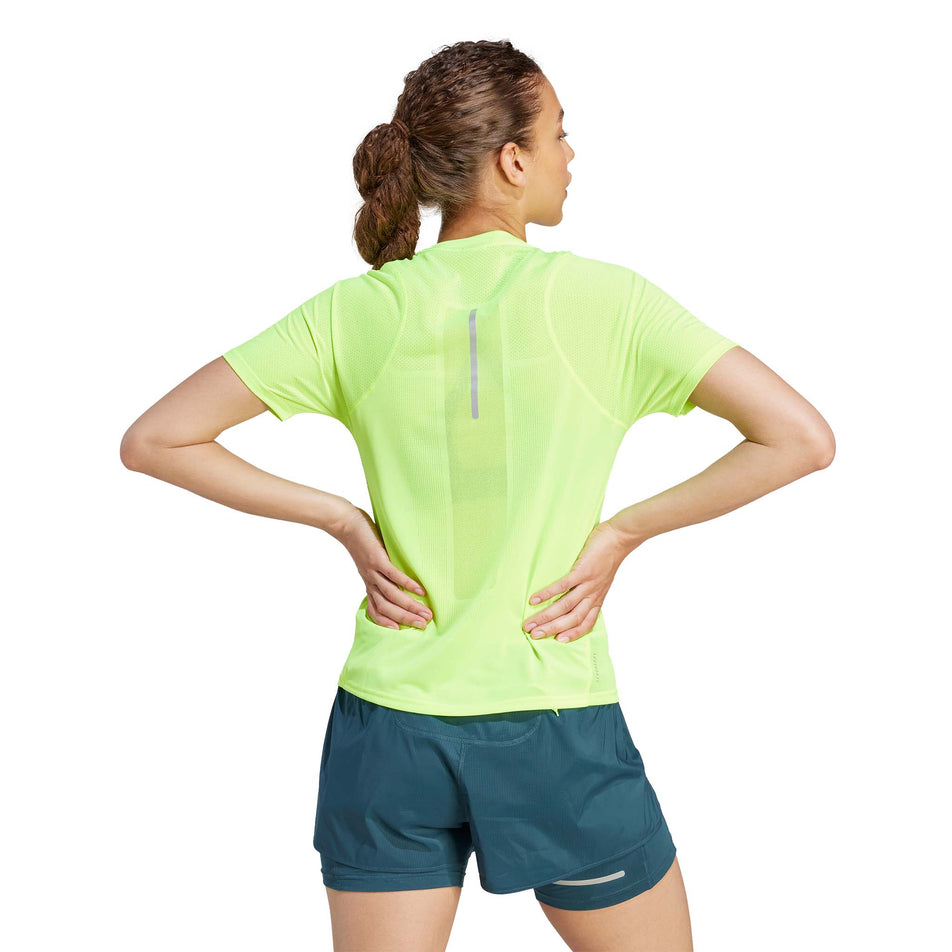 Back view of a model wearing an adidas Women's Ultimate Knit T-Shirt in the Lucid Lemon colourway (8005345771682)
