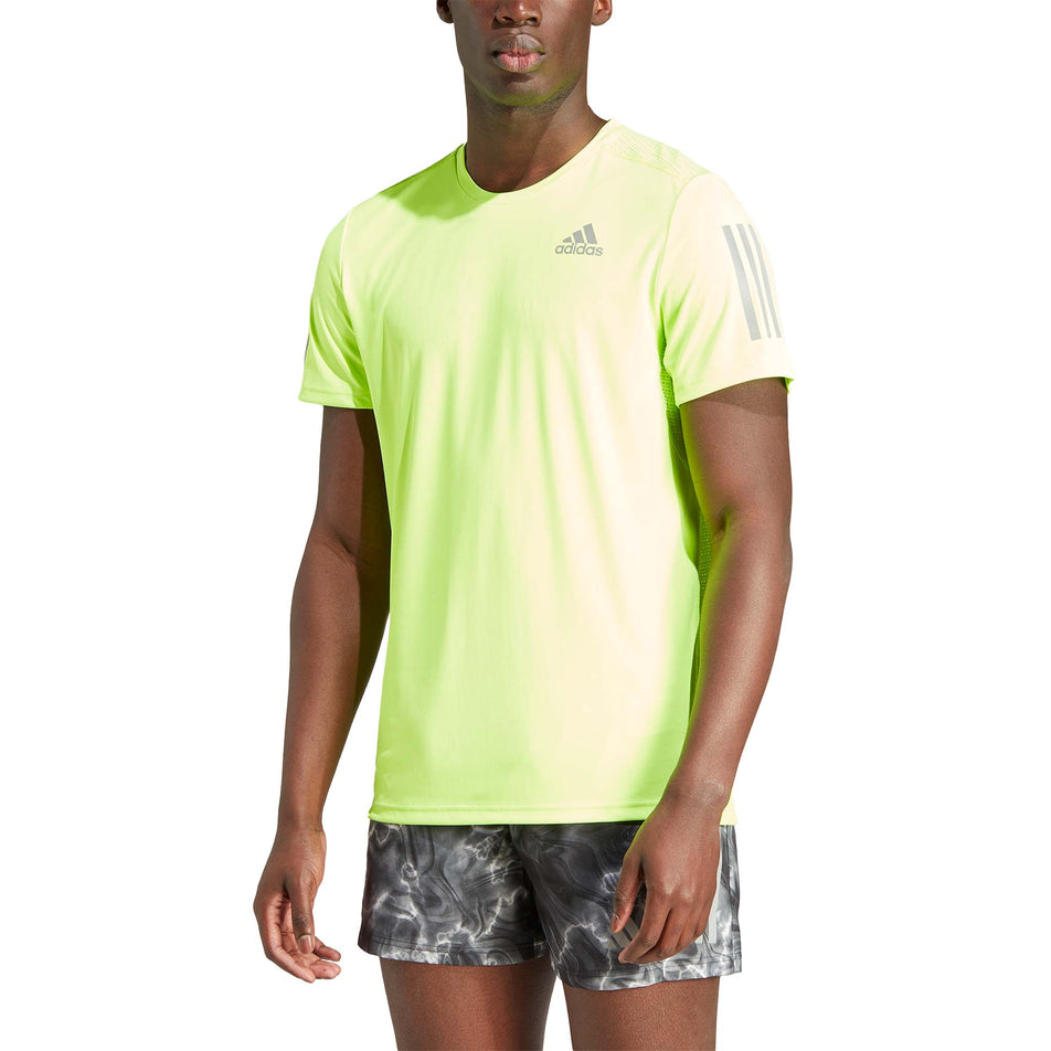 Front view of a model wearing an adidas Men's Own the Run Tee in the Lucid Lemon colourway (8005317394594)