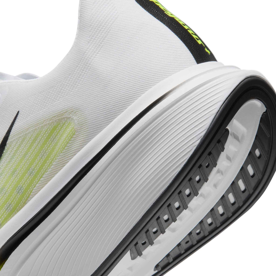 Close-up view of the rearfoot section of the left shoe from a pair of Nike Men's Pegasus Plus 2 Road Running Shoes in the White/Black-Lemon Venom colourway.
