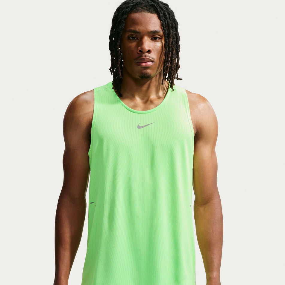Front view of a model wearing the Nike Men's Stride Aero-FIT Running Tank Top in the Volt/Light Silver/Reflective Silver colourway.