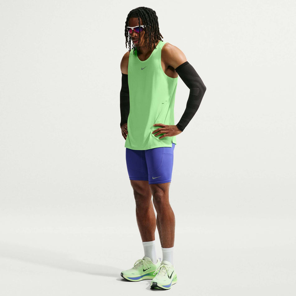 Front view of a model wearing the Nike Men's Stride Aero-FIT Running Tank Top in the Volt/Light Silver/Reflective Silver colourway.