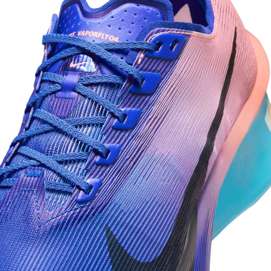 Close-up view of the upper of the left shoe from a pair of Nike Men's Vaporfly 4 Road Racing Shoes in the Racer Blue/White-Blue Lightning colourway.