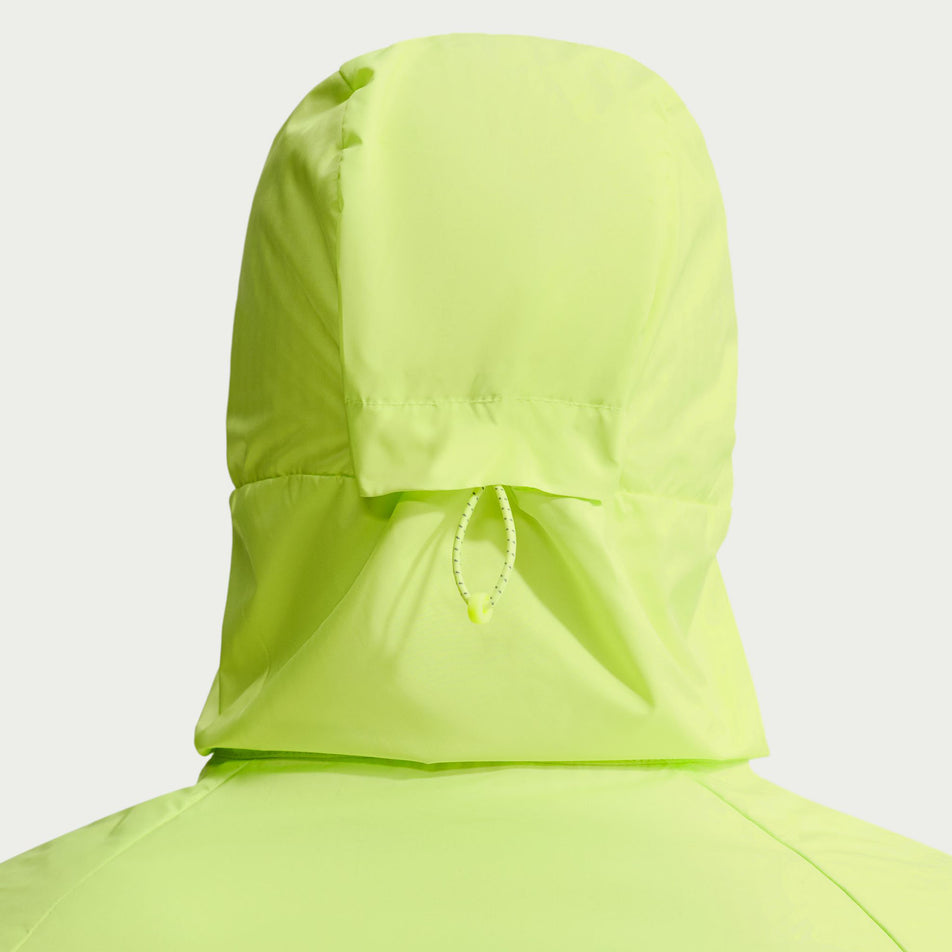 Back view of a model wearing the Nike Men's Miler Therma-FIT Repel Winterized Running Jacket in the Light Lemon Twist colourway.