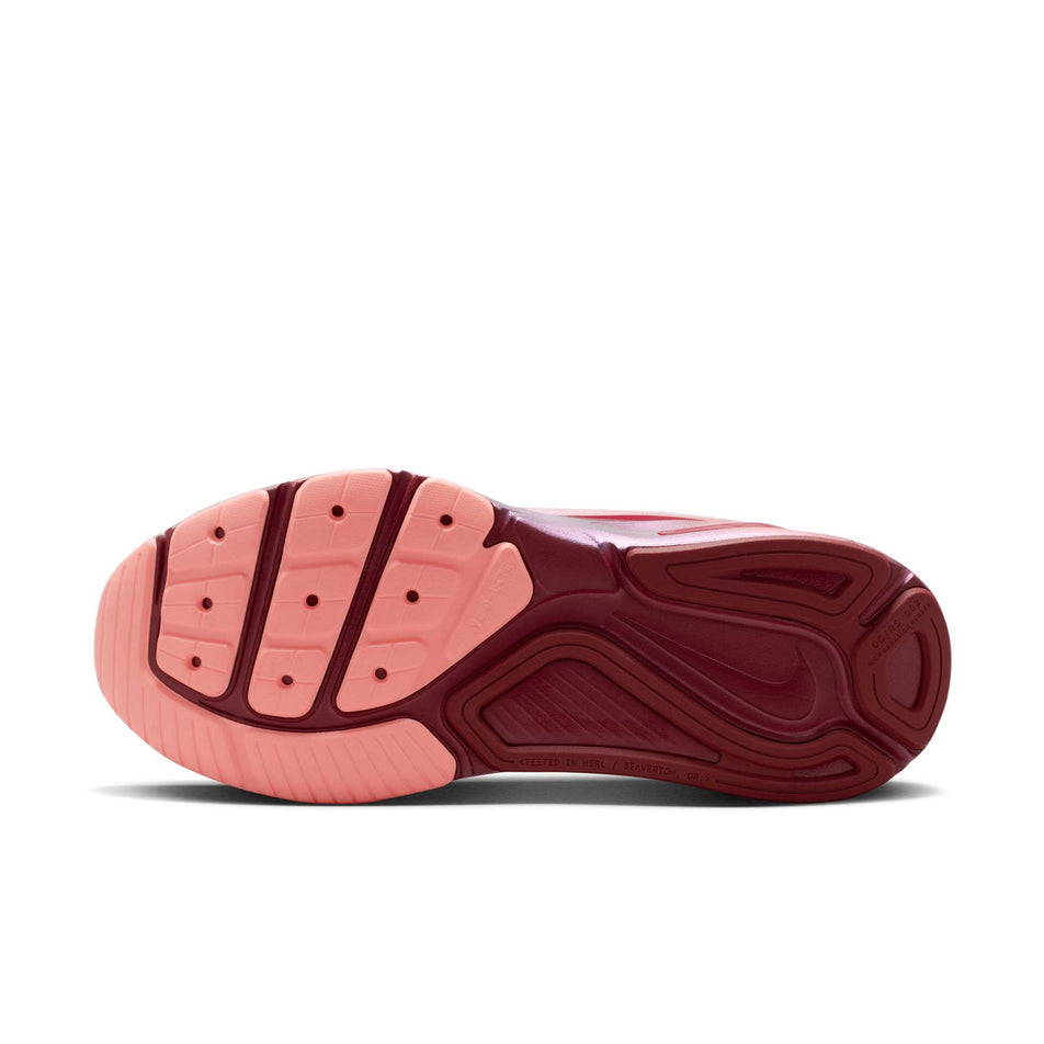 The outsole of the left shoe from a pair of Nike Women's Structure 26 Road Running Shoes in the Light Redwood/Barely Green-Team Red colourway.