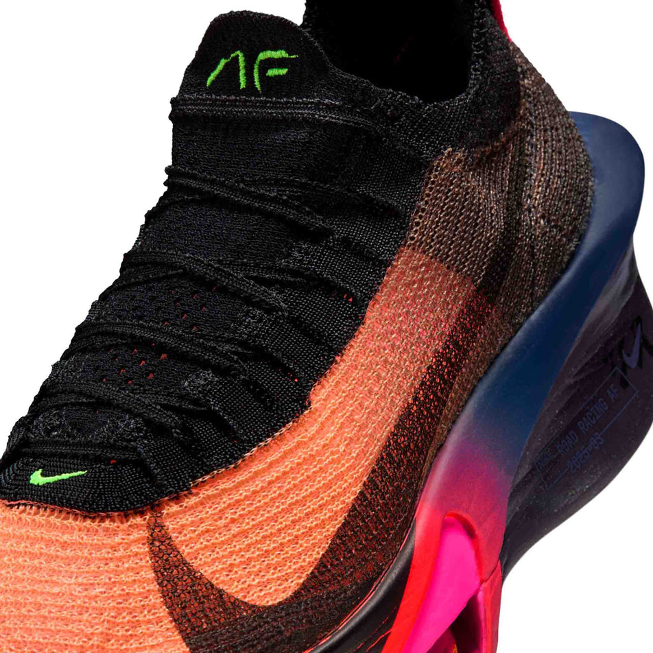 Close-up view of the upper of the left shoe from a pair of Nike Women's Alphafly 3 Road Racing Shoes in the Orange Pulse/Black-Purple Dynasty colourway.