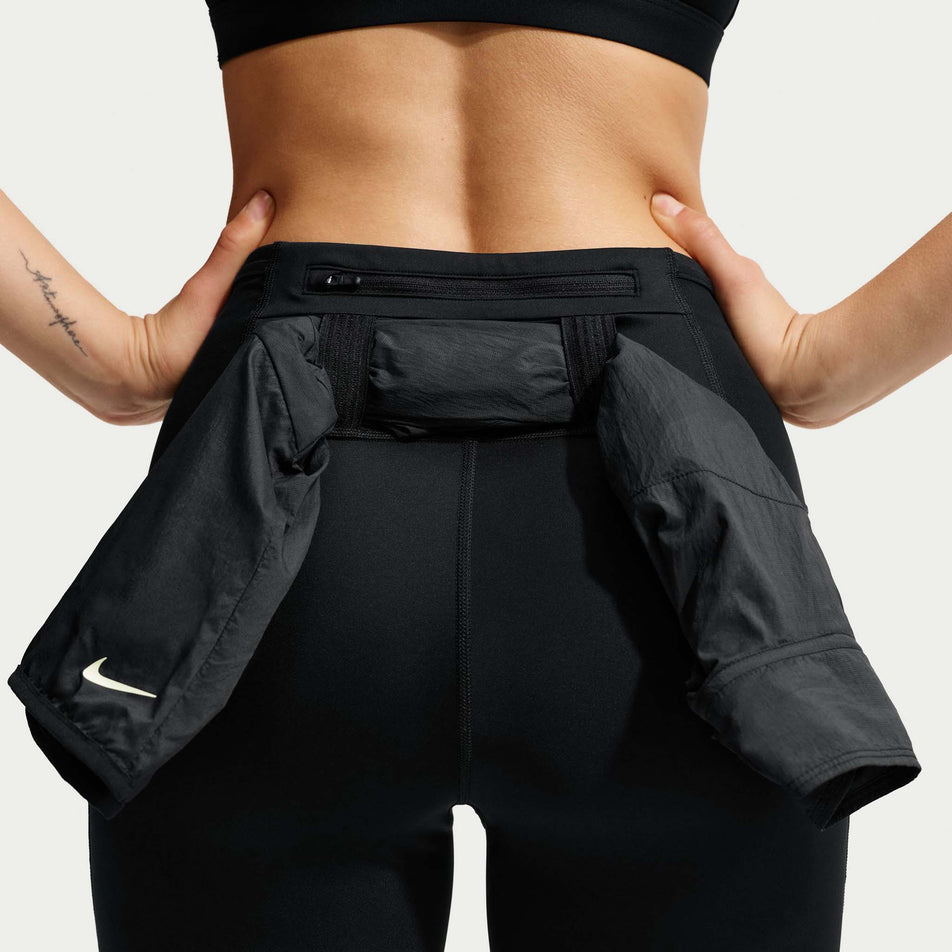 The storage loops on the back of the Nike Women's ACG Dri-FIT High-Waisted 7/8 Trail Running Leggings in the Black/Summit White colourway.