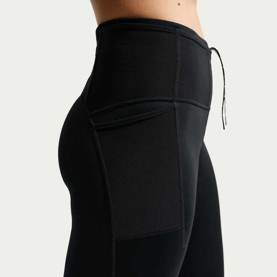 The side stash pocket on the Nike Women's ACG Dri-FIT High-Waisted 7/8 Trail Running Leggings in the Black/Summit White colourway.