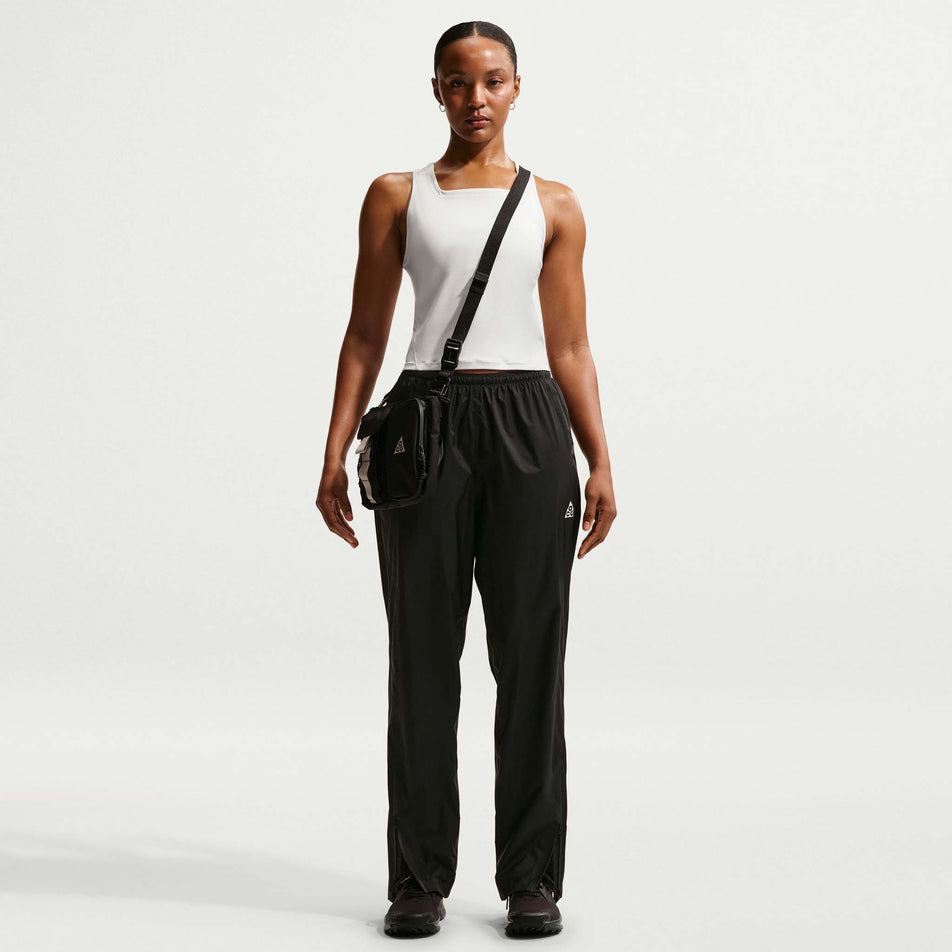 Front view of a model wearing the Nike Women's ACG Dri-FIT Trail Running Tank Top in the Phantom/Photon Dust/Summit White colourway.