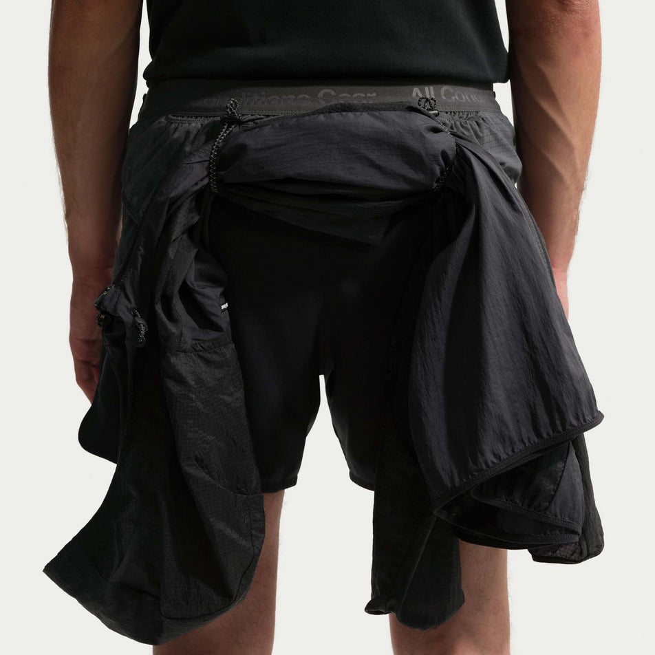 An example of a jacket being stowed in the loops on the back of the Nike Men's ACG 