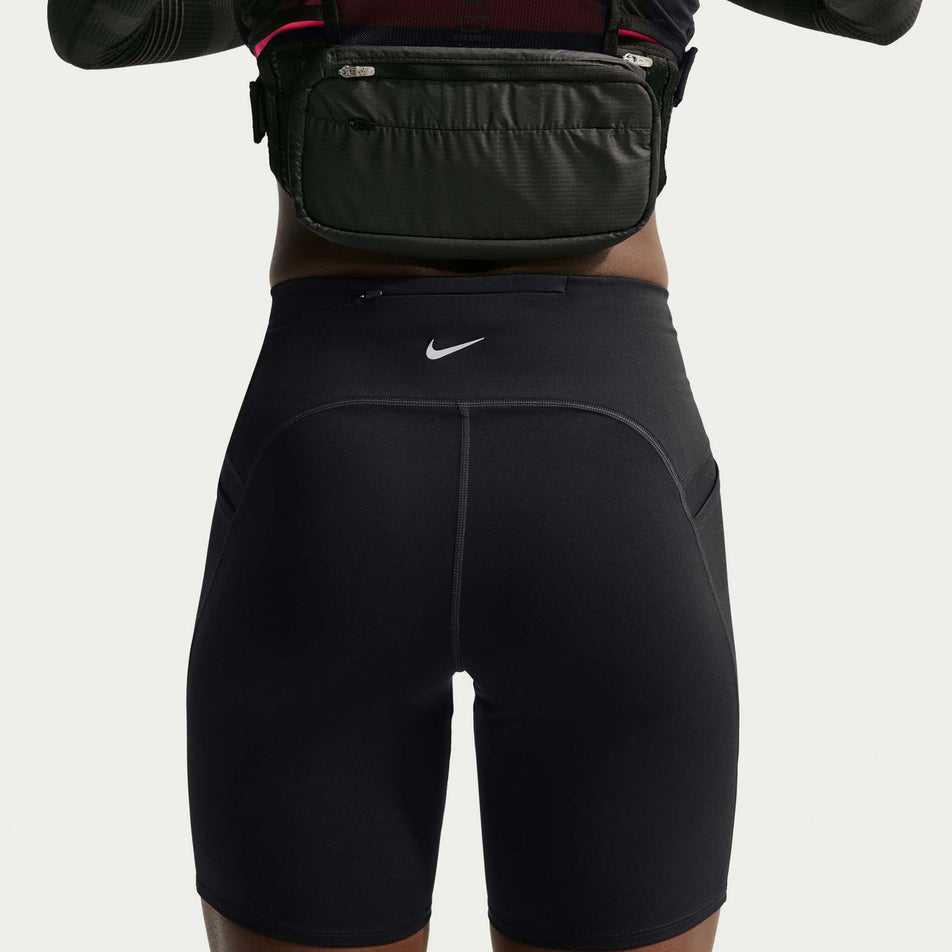 Back view of a model wearing the Nike Women's Swift Dri-FIT High-Waisted 7