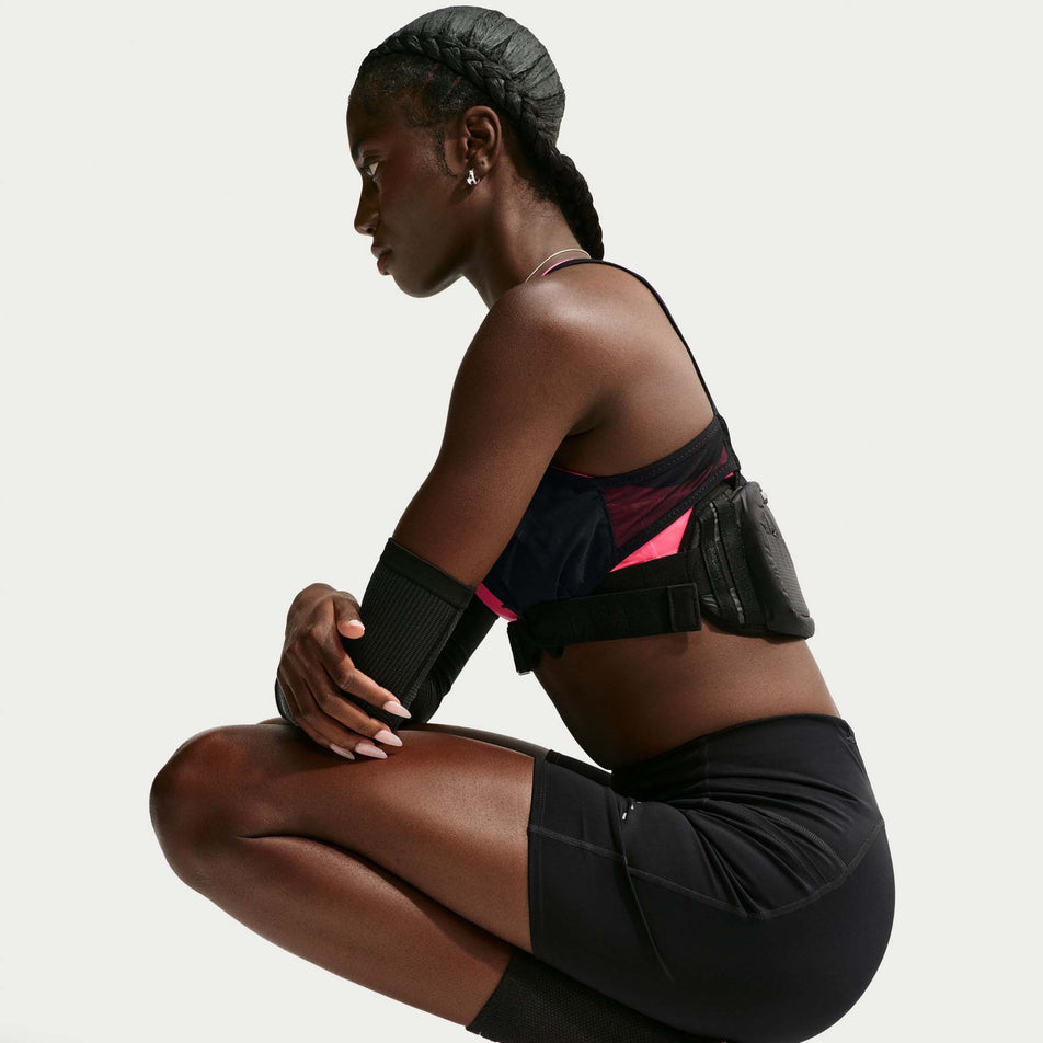 Side view of a model wearing the Nike Women's Swift Dri-FIT High-Waisted 7
