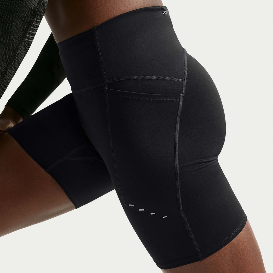 Side view of a model wearing the Nike Women's Swift Dri-FIT High-Waisted 7
