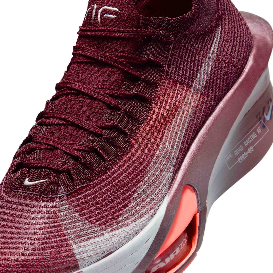 Close-up view of the upper of the left shoe from a pair of Nike Women's Alphafly 3 Road Racing Shoes in the Team Red/Barely Green-Bright Crimson colourway.
