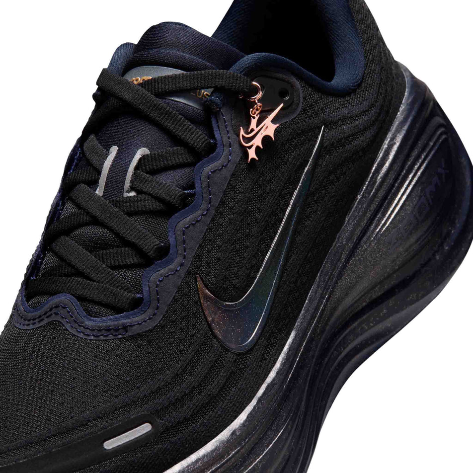 Close-up view of the upper of the left shoe from a pair of Nike Women's Vomero Plus 