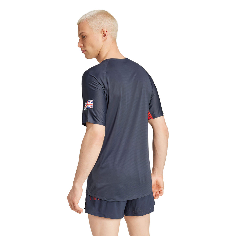 Back view of a model wearing an adidas Men's Team GB Adizero Running T-Shirt in the Legend Ink colourway. Model is also wearing adidas shorts. (8324017553570)