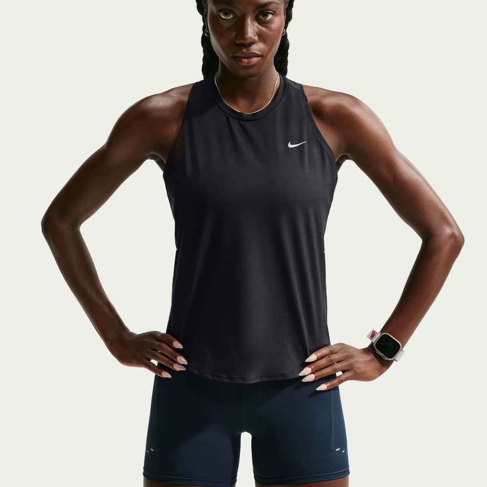 Front view of a model wearing the Nike Women's Swift Dri-FIT Running Tank Top in the Black/Reflective Silver colourway.