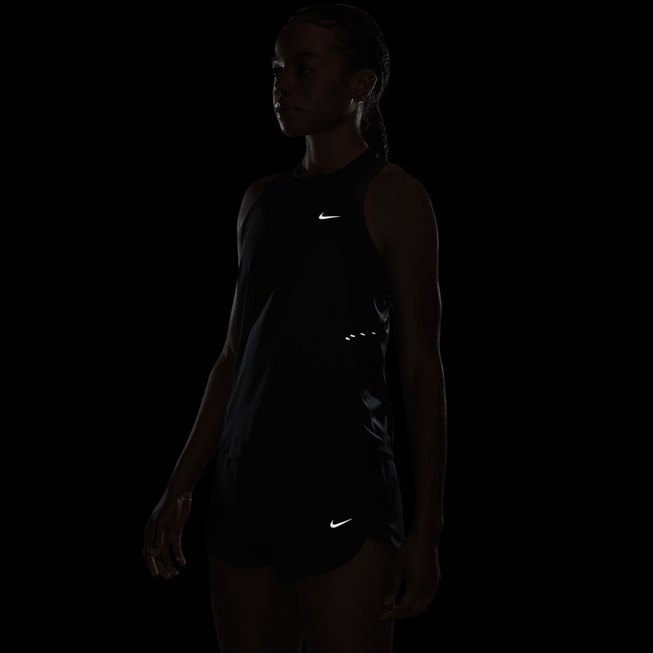 The reflective graphics on the Nike Women's Swift Dri-FIT Running Tank Top in the Black/Reflective Silver colourway.
