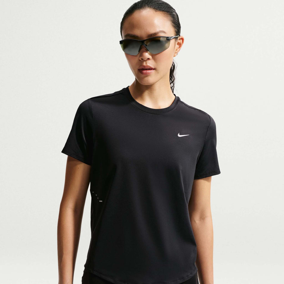Front view of a model wearing the Nike Women's Swift Dri-FIT Short-Sleeve Running Top in the Black/Reflective Silver colourway.