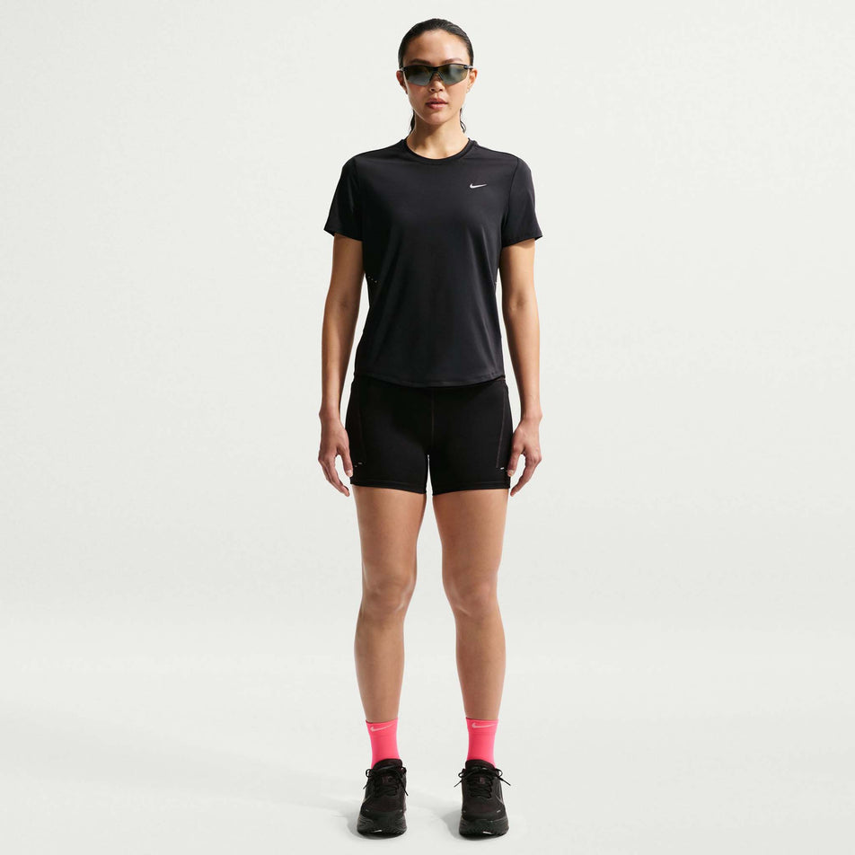 Front view of a model wearing the Nike Women's Swift Dri-FIT Short-Sleeve Running Top in the Black/Reflective Silver colourway.