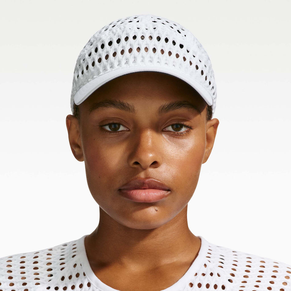Front view of a model wearing the Nike Unisex ACG Radical AirFlow Fly Cap in the White/White colourway.