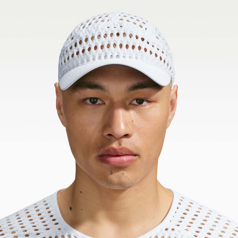 Front view of a model wearing the Nike Unisex ACG Radical AirFlow Fly Cap in the White/White colourway.