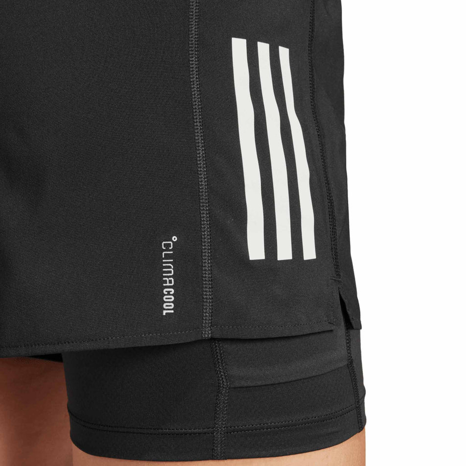 Close up of the CLIMACOOL branding on the adidas Women's Own The Run Base 2in1 Short in the Black colourway. (8665239847074)