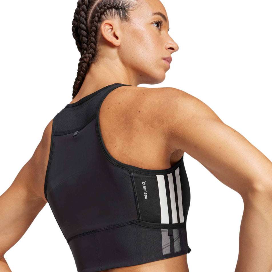 Back view of a model wearing the adidas Women's Adizero Running Gel Pocket Crop in the Black colourway.