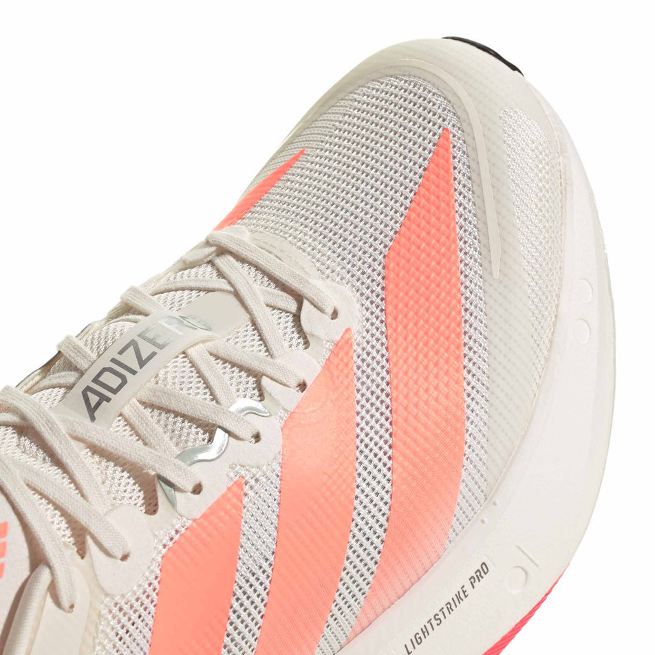 Close-up view of the toebox of the right shoe from a pair of adidas Men's Adizero Boston 13 Running Shoes in the Off White/Lucid Orange/Grey colourway.