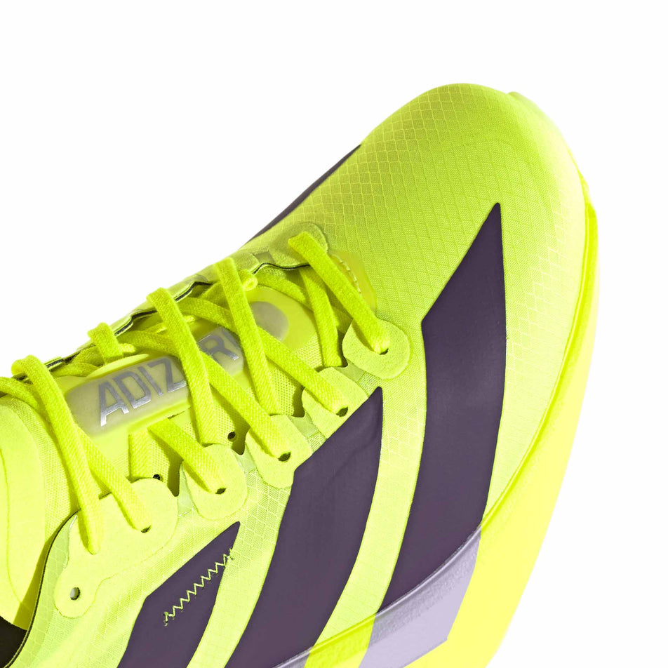 The toe box of the right shoe from a pair of adidas Women's Adizero Adios Pro 4 Running Shoes in the Solar Yellow/Aurora Plum/Powder Plum colourway.