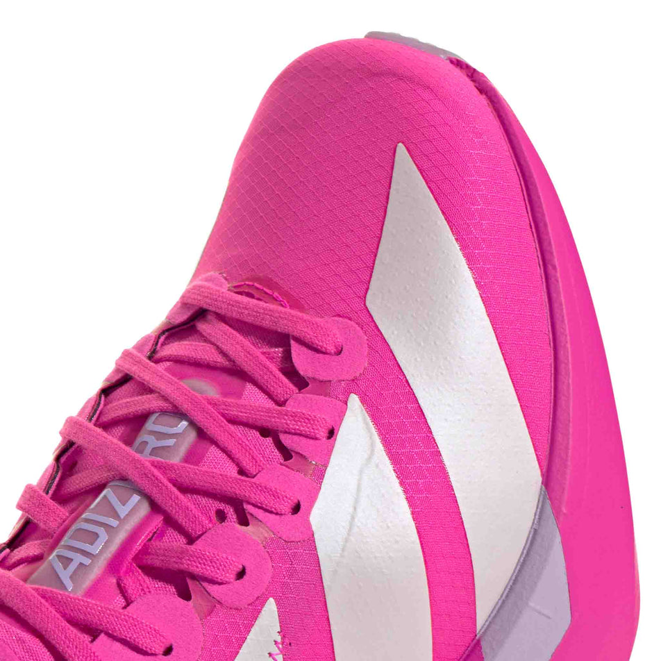 Close-up view of the upper of the adidas Women's Adizero Adios Pro 4 Running Shoes in the Shock Pink/Zero Met./Aurora Plum colourway. (8745995337890)