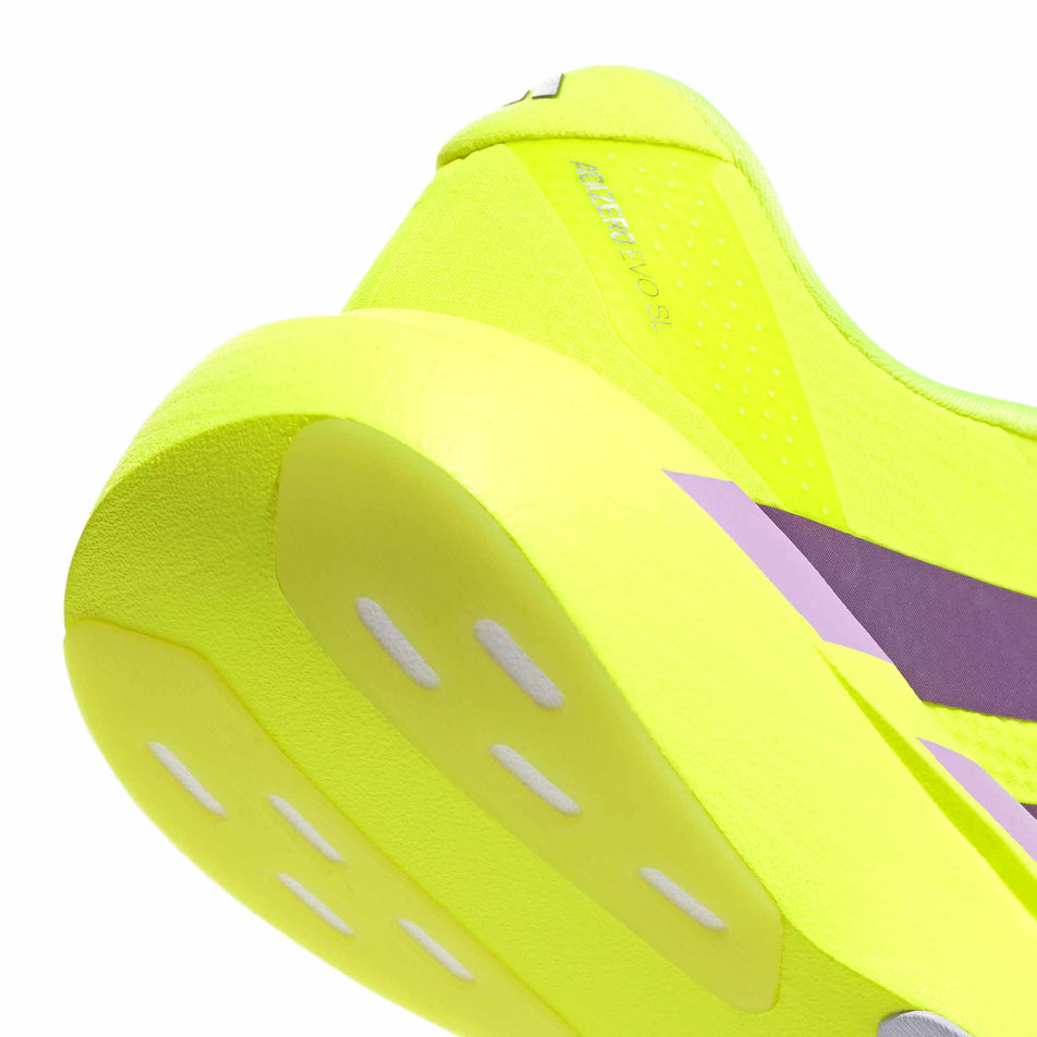 The rearfoot section of the right shoe from a pair of adidas Women's Adizero EVO SL Woven Running Shoes in the Solar Yellow/Aurora Plum/Powder Plum colourway.