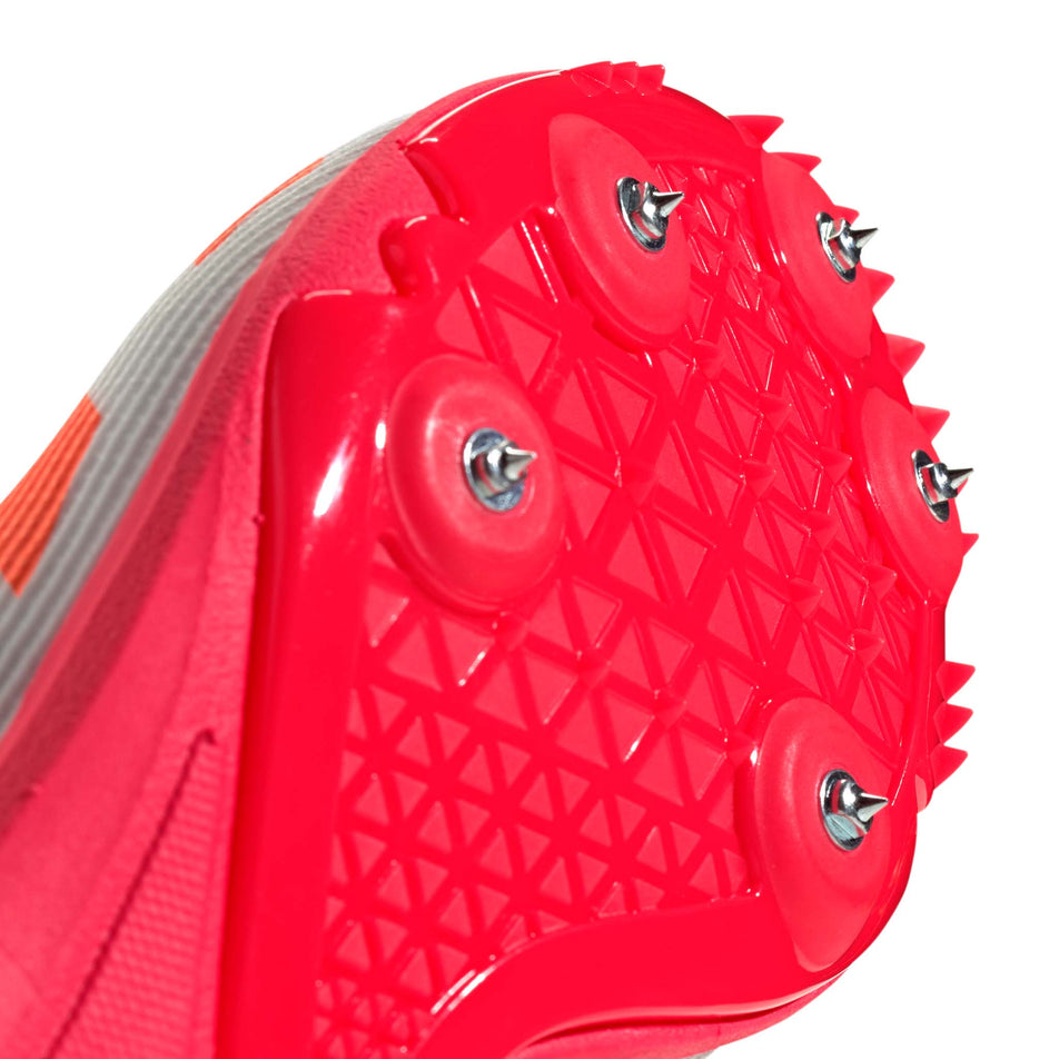 Close-up view of the spike plate of the right shoe from a pair of adidas Junior-Unisex Allroundstar Running Spikes in the Pure Orange/Core Black/Silver Met. colourway.