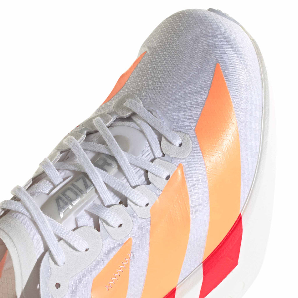 Close-up view of the toe box of the right shoe from a pair of adidas Women's Adizero Adios Pro 4 Running Shoes in the Ftwr White/Beam Orange/Lucid Red colourway.