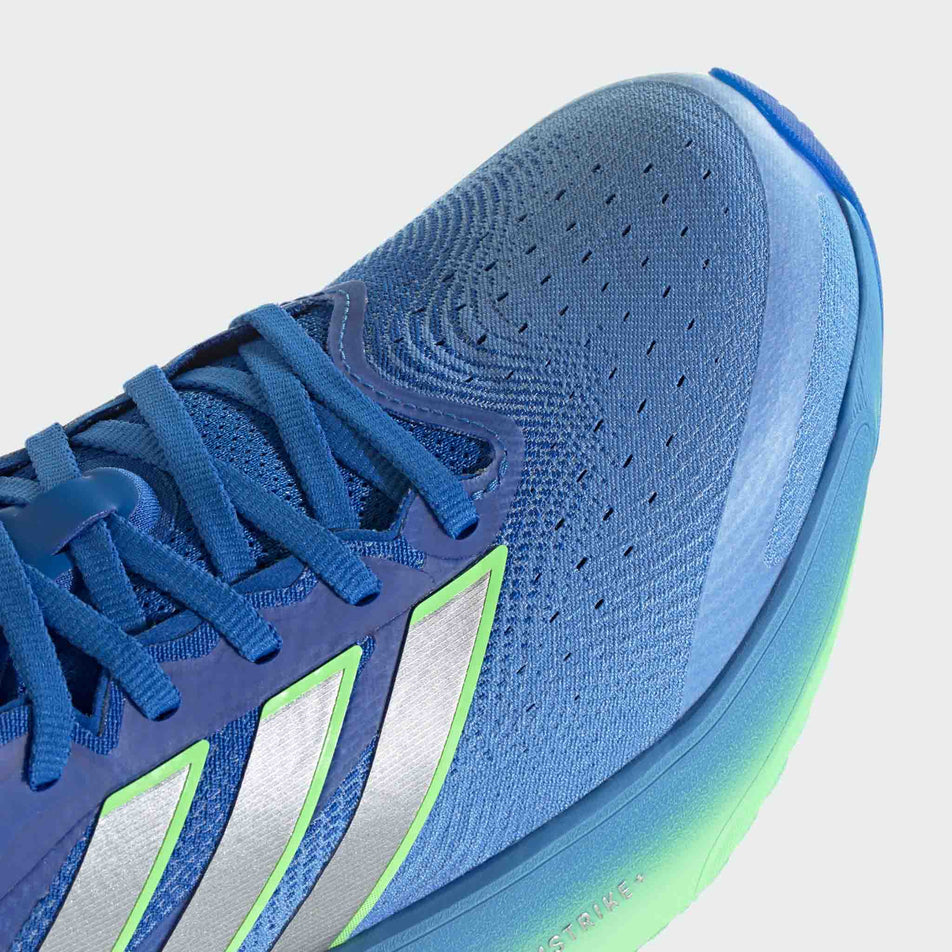 Close-up view of the toe box of the right shoe from a pair of adidas Men's Supernova Solution 3 Running Shoes in the Lucky Blue/Silver met./Lime Burst colourway.