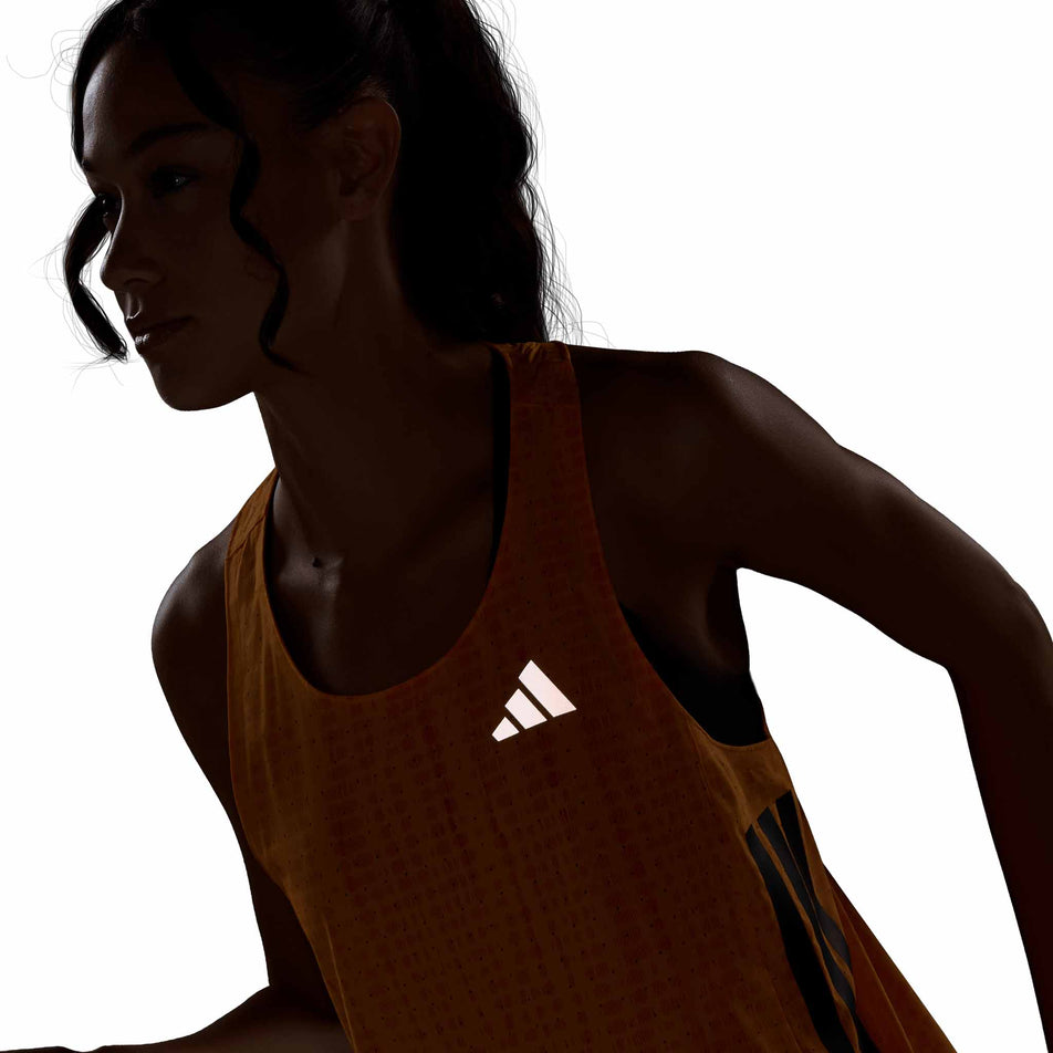 The reflective adidas logo on the adidas Women's Adizero Singlet in the Pure Tangerine/Pure Orange colourway.