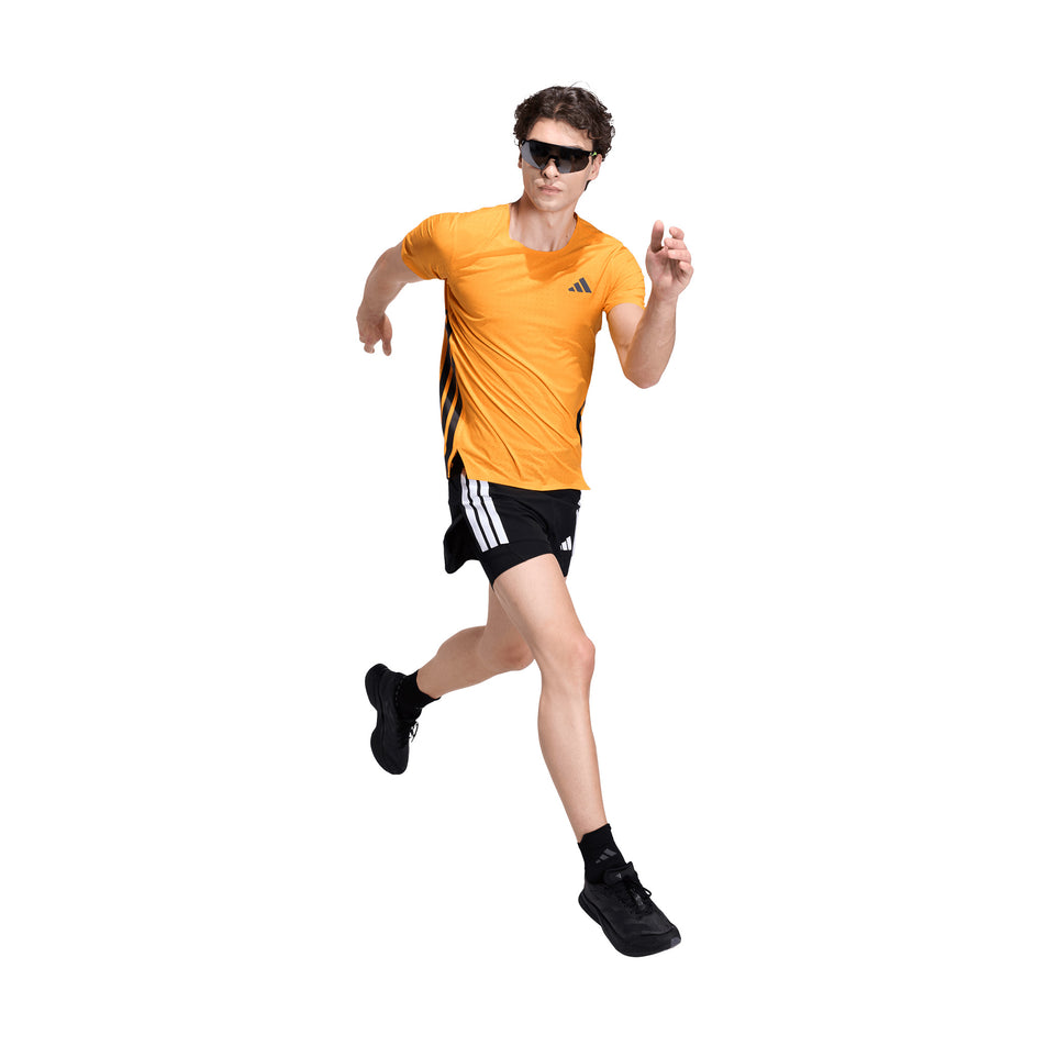 Front view of a model wearing the adidas Men's Adizero Tee in the Pure Tangerine colourway.