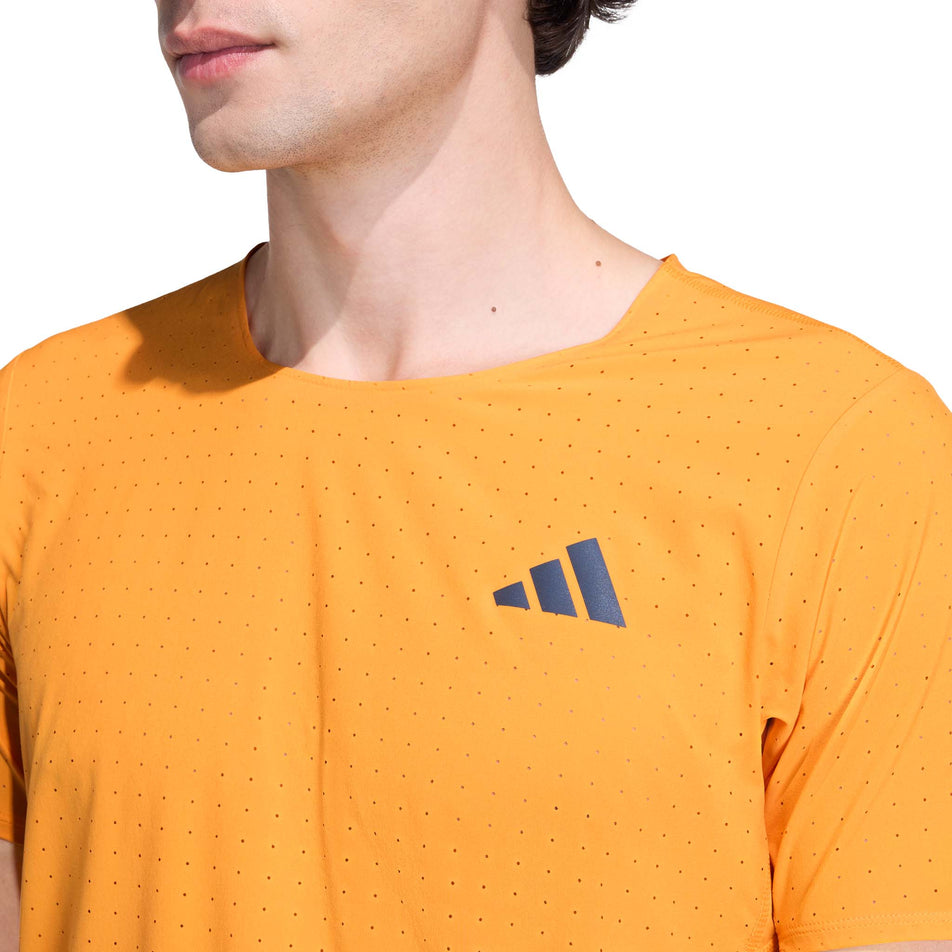 Front view of a model wearing the adidas Men's Adizero Tee in the Pure Tangerine colourway.