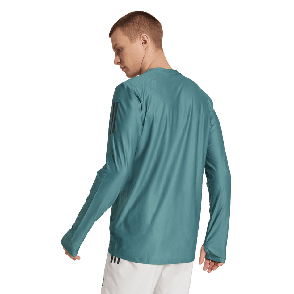Back view of a model wearing the adidas Men's Own The Run Base Long Sleeve in the Preloved Teal colourway. (8751018180770)