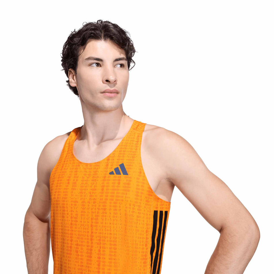 Front view of a model wearing the adidas Men's Adizero Singlet in the Pure Tangerine/Pure Orange colourway.