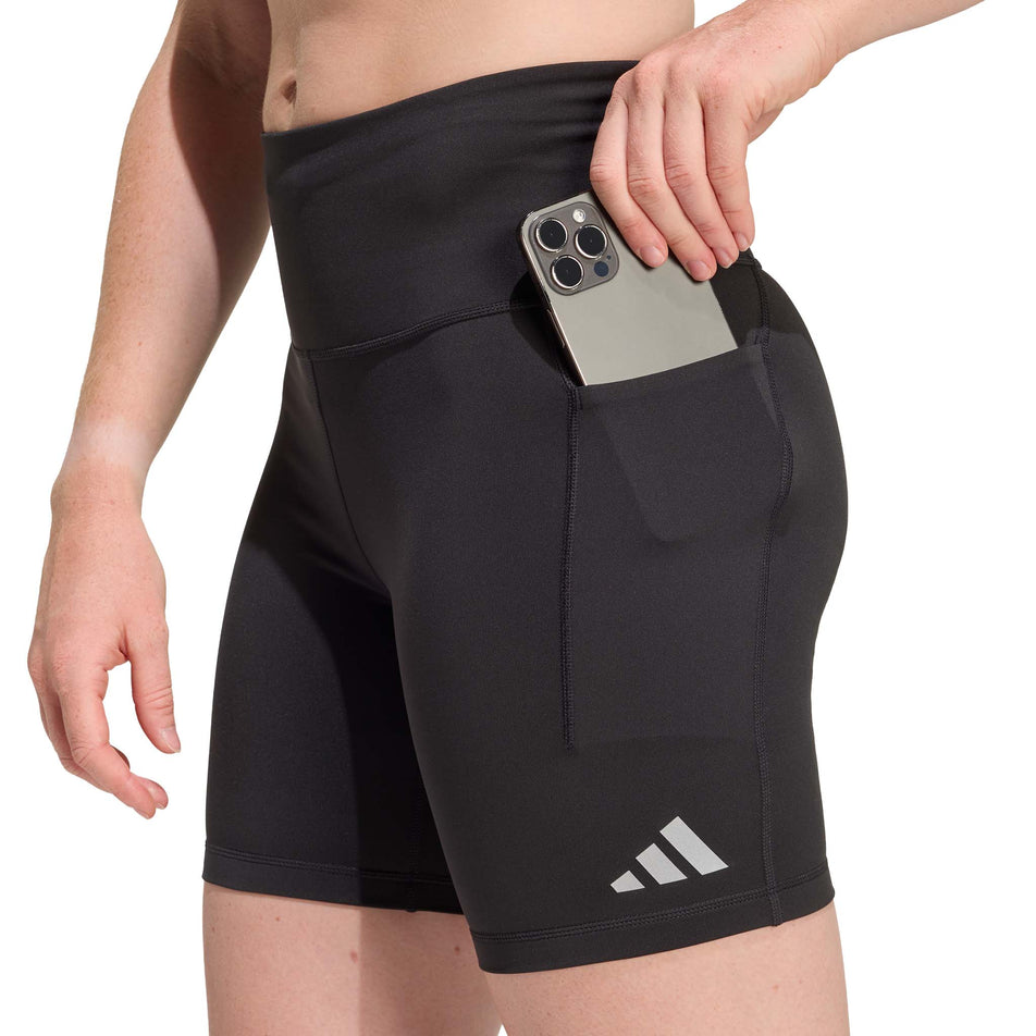 A model demonstrating the drop-in stash pocket on the side of the adidas Women's adi365 Climacool Running Short Leggings in the Black colourway.