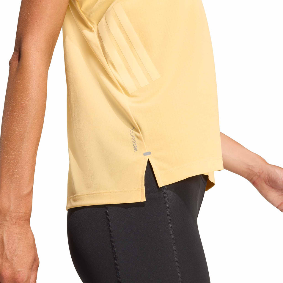 Side view of a model wearing the adidas Women's adi365 Climacool Tank Top in the Semi Ice Tangerine colourway.