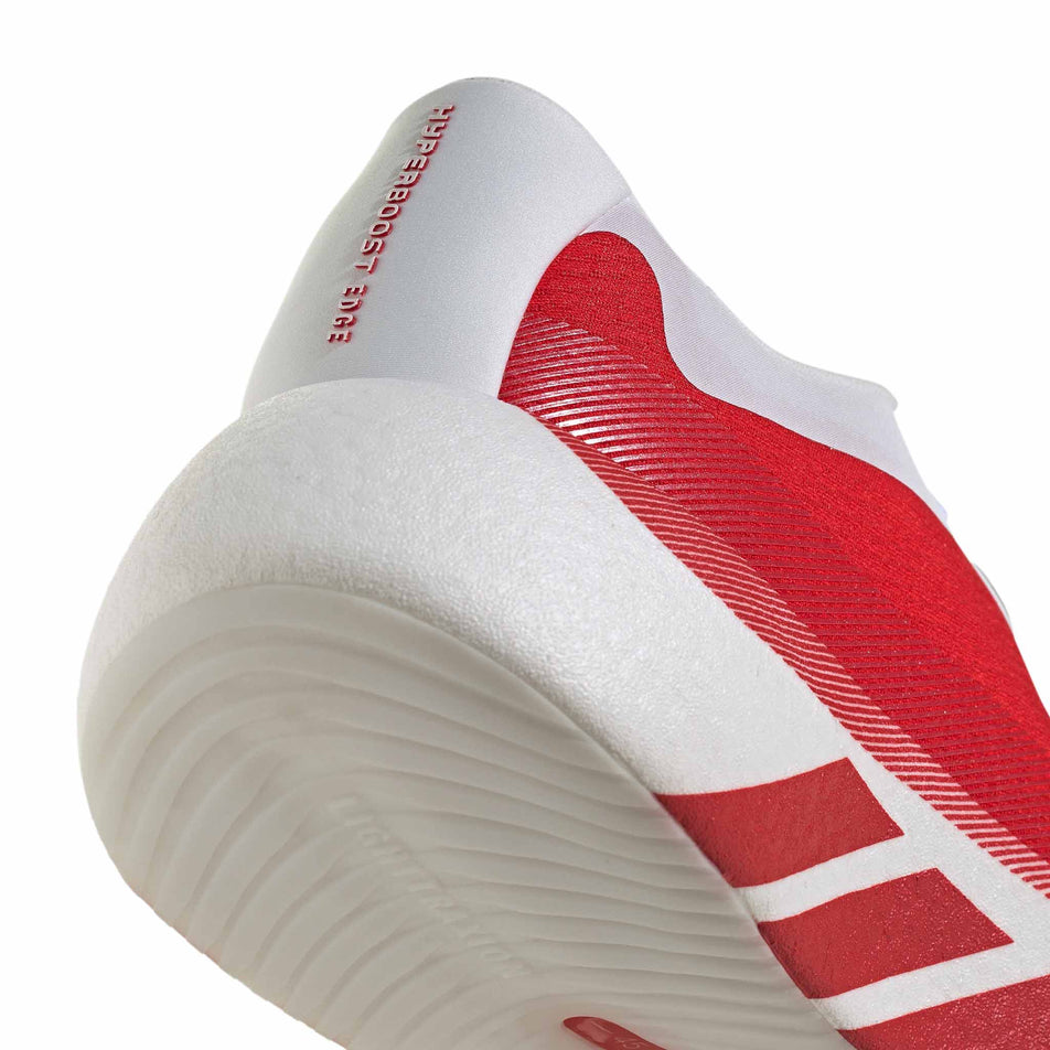 The rearfoot section of the right shoe from a pair of adidas Men's Hyperboost Edge Running Shoes in the Ftwr White/Pure Ruby/Zero Met. colourway.