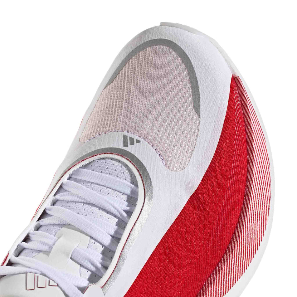 Close-up view of the toe box of the right shoe from a pair of adidas Men's Hyperboost Edge Running Shoes in the Ftwr White/Pure Ruby/Zero Met. colourway.