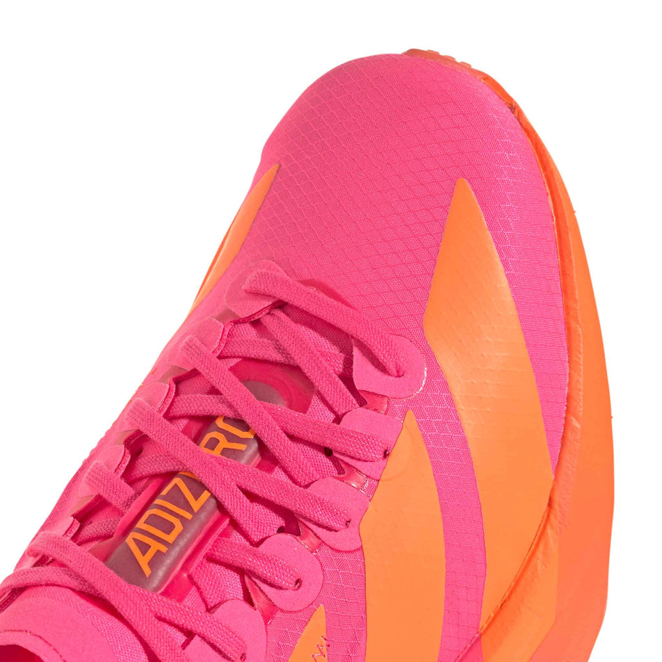 The toe box of the right shoe from a pair of adidas Women's Adizero Adios Pro 4 Running Shoes in the Lucid Pink/Lucid Orange/Iron Met. colourway.