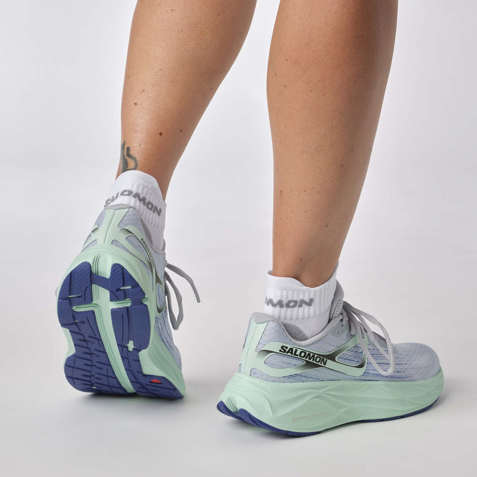 Back view of a model wearing a pair of Salomon Women's Aero Glide 2 Running Shoes in the Pearl Blue/Yucca/Clematis Blue colourway (7772908159138)