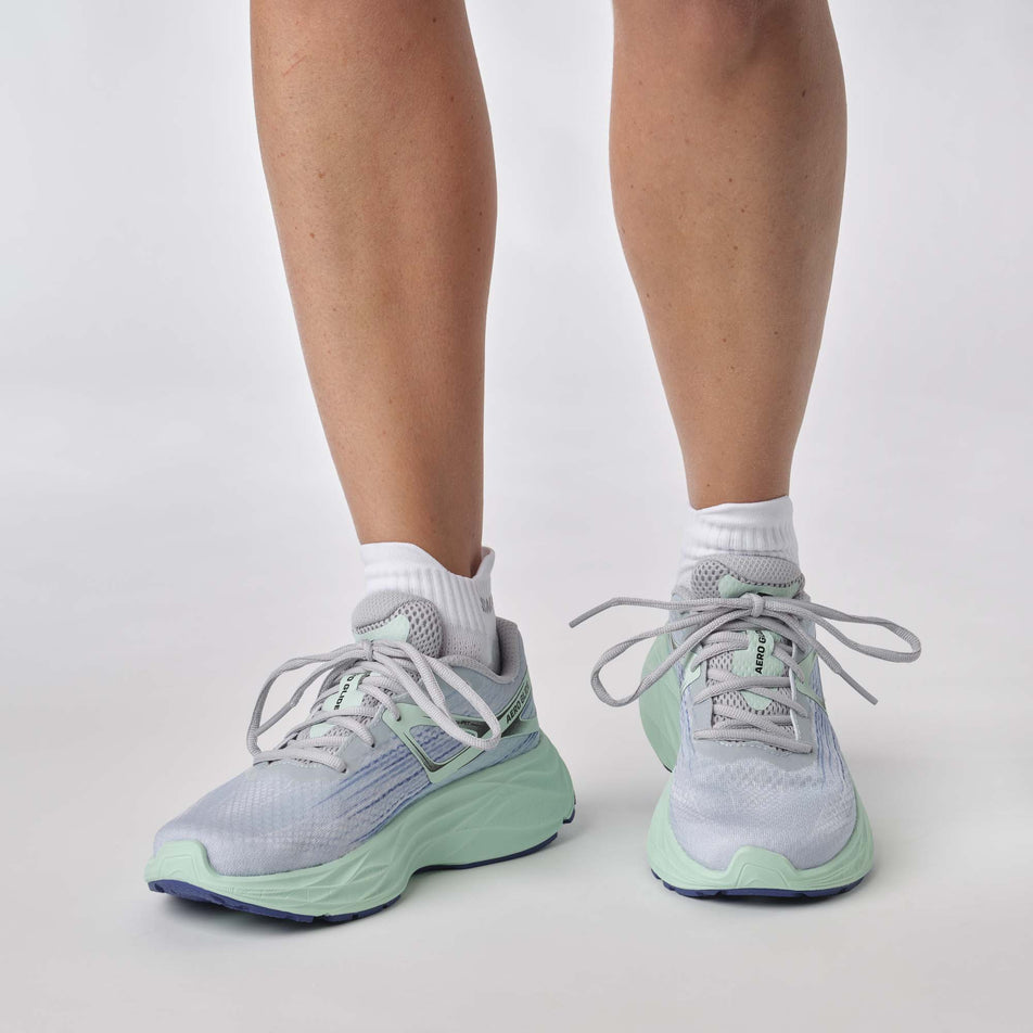 Front view of a model wearing a pair of Salomon Women's Aero Glide 2 Running Shoes in the Pearl Blue/Yucca/Clematis Blue colourway (7772908159138)