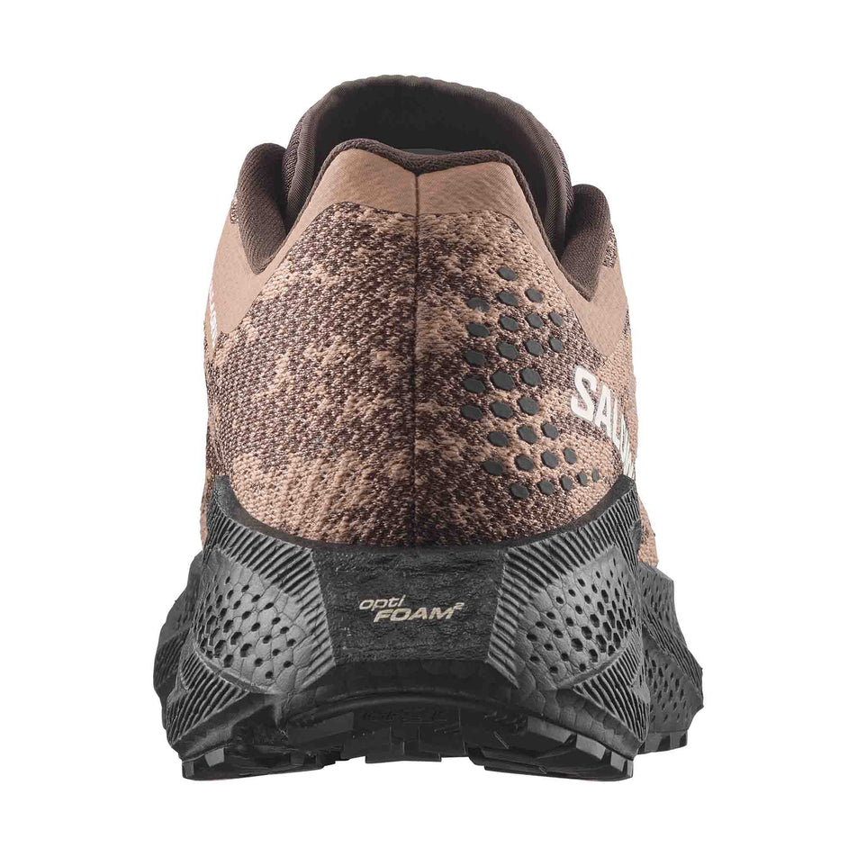 The back of the right shoe from a pair of Salomon Men's Aero Glide 4 GRVL Running Shoes in the Burro/Black colourway.