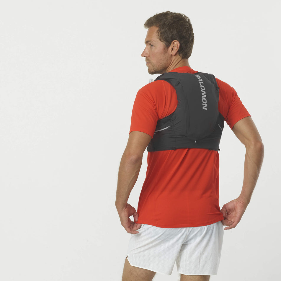 Back of a model wearing a Salomon Unisex Sense Pro 10 Running Vest in the Black/Ebony colourway, with flasks included. (7992933253282)