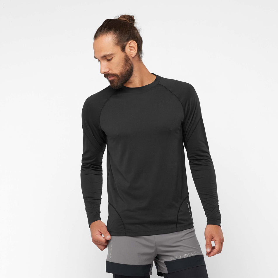 Front view of a model wearing a Salomon Men's Cross Run Long Sleeve T-Shirt in the Deep Black colourway (8008540324002)