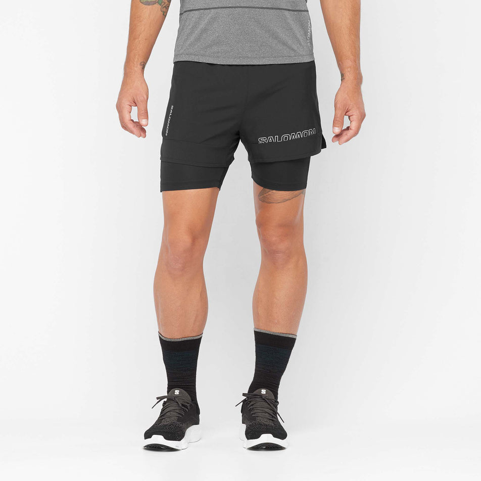Front view of a model wearing a pair of Salomon Men's Cross 2in1 Shorts in the Deep Black colourway (8008550121634)